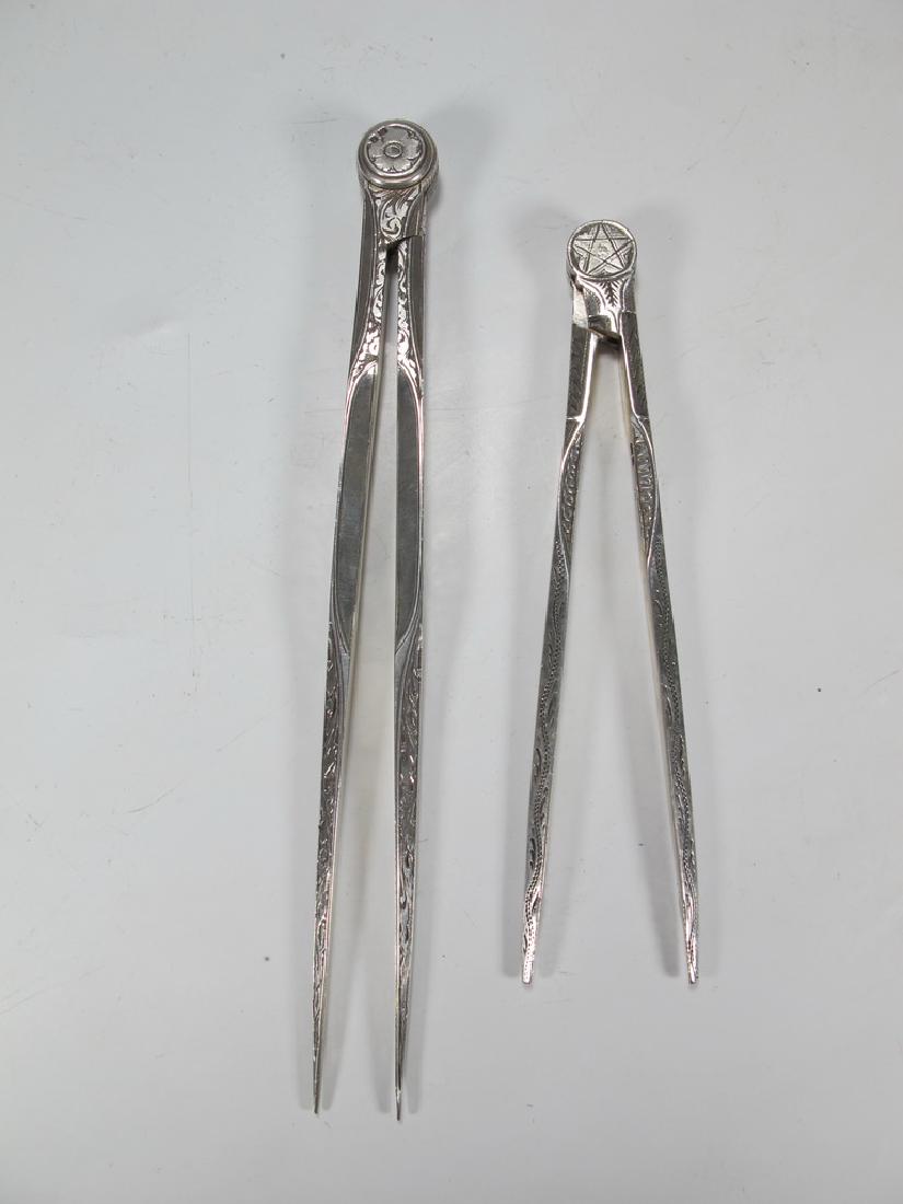 Pair of antiques Masonic Victorian compasses: 232-L793 George V and 233-L794 Victorian silver Masonic compasses with engraved foliate decoration, marked. Weight: 130 grams (4t oz 3.591942 dwt). 6 7/8" long and 5 1/4" long. Shipping in USA or Inte