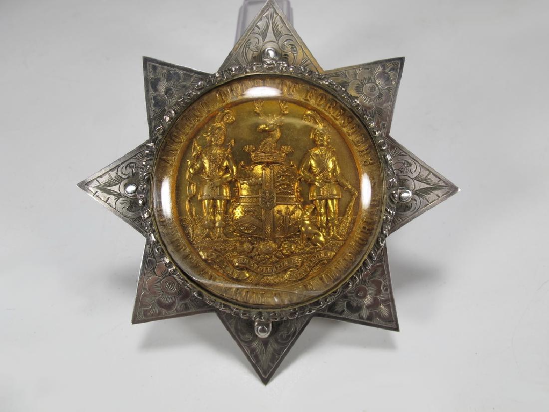 Antique English Order of Foresters silver star brooch: Antique Foresters silver star with a glass cover. Gilt centre with the badge of Ancient Order of Foresters. 3 1/2" H x 3 3/8" W. Weight: 55 grams (1t oz 15.36582 dwt). Shipping in USA or International