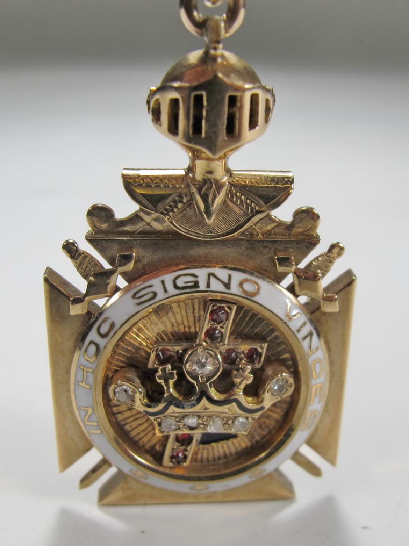 Masonic 9K gold Scottish Rite Knights Templar fob: Masonic 9K gold Scottish Rite Knights Templar fob. Movable knight"™s bust atop the Maltese Cross. White enamel accent. Crown and crucifix in the center. Rubies and diamonds accents. The back of the 
