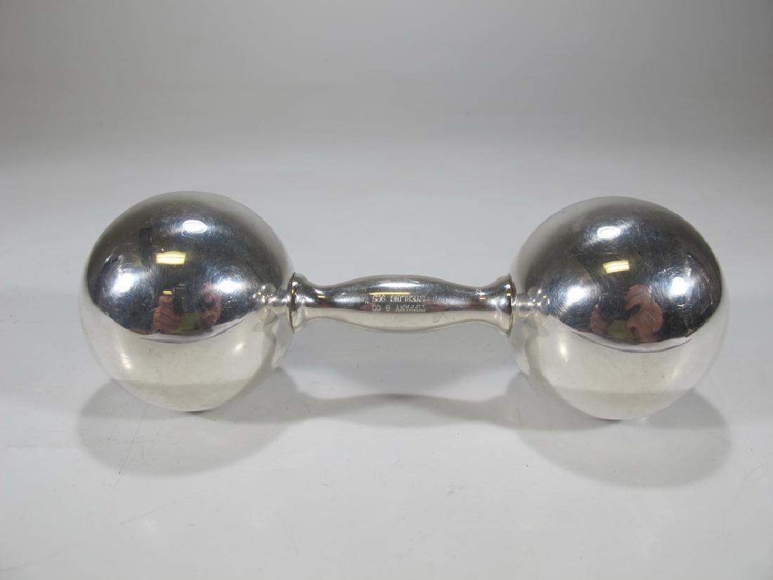 Tiffany & Co sterling 925 baby rattle: Tiffany & Co sterling 925 baby rattle, signed. 1 3/4 in H x 5 in W. Weight: 77.6 grams (2t oz 9.897959 dwt). Shipping in USA or International please contact for quote: James Lawrence UPS Store 4356 - 