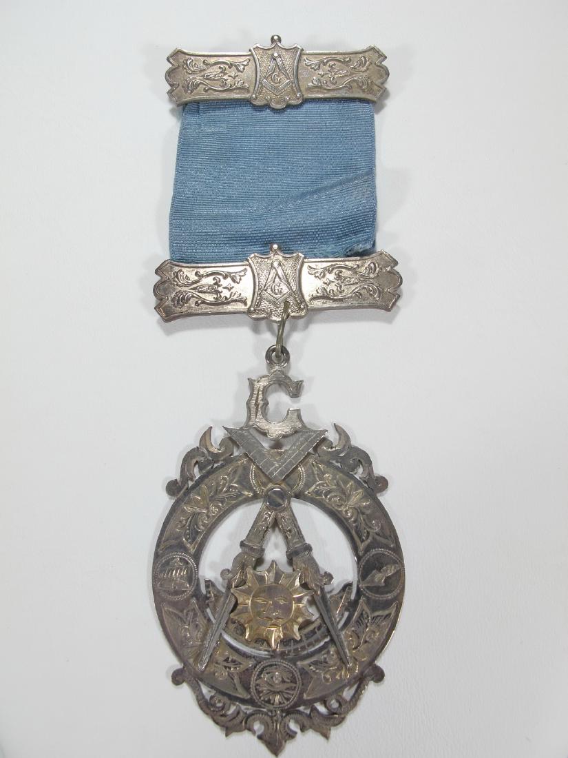 Antique Masonic sterling jewel on ribbon: Antique Masonic sterling jewel on ribbon, marked. 5 5/8 in H x 2 in W. Weight: 29.8 grams (0t oz 19.16185 dwt). Shipping in USA or International please contact both UPS stores for quote: James Lawrenc