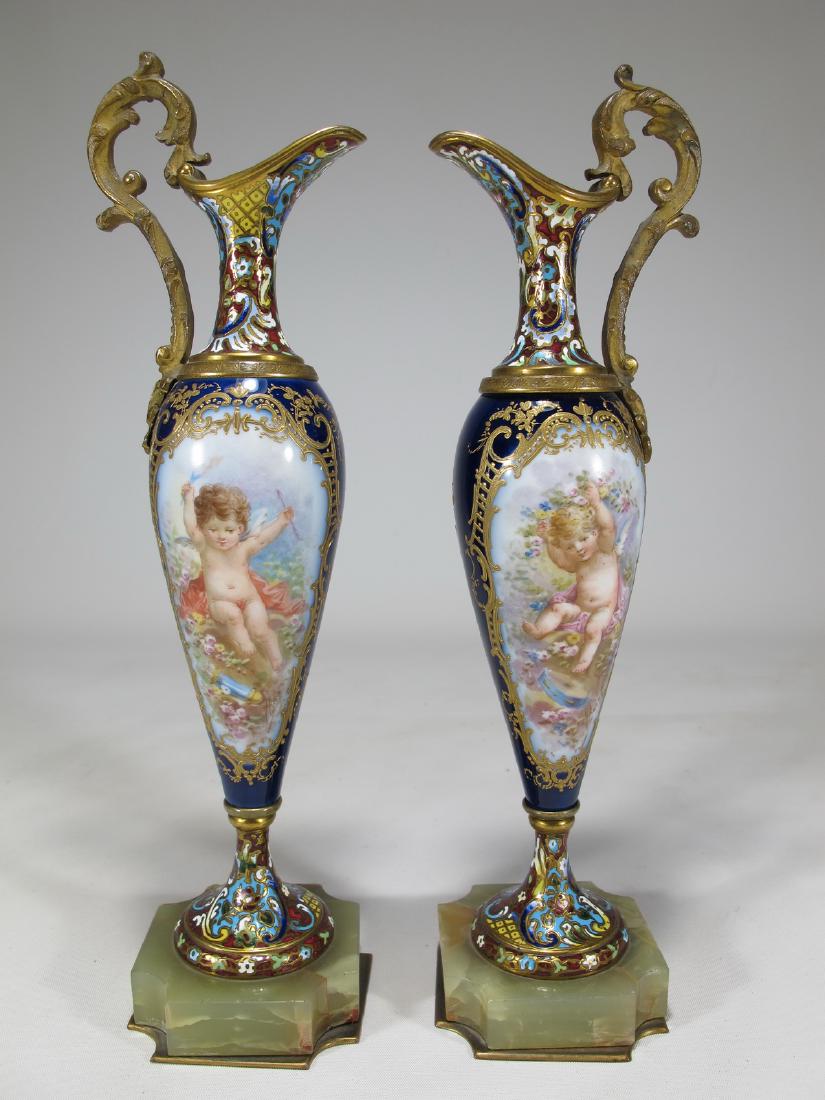 Antique pair of French Sevres bronze champleve &: Antique pair of French Sevres bronze champleve & porcelain pitchers, signed. 10 in H x 2 3/8 in W x 2 3/8 in D. Shipping in USA or International please contact for quote both UPS stores: 1) : James La