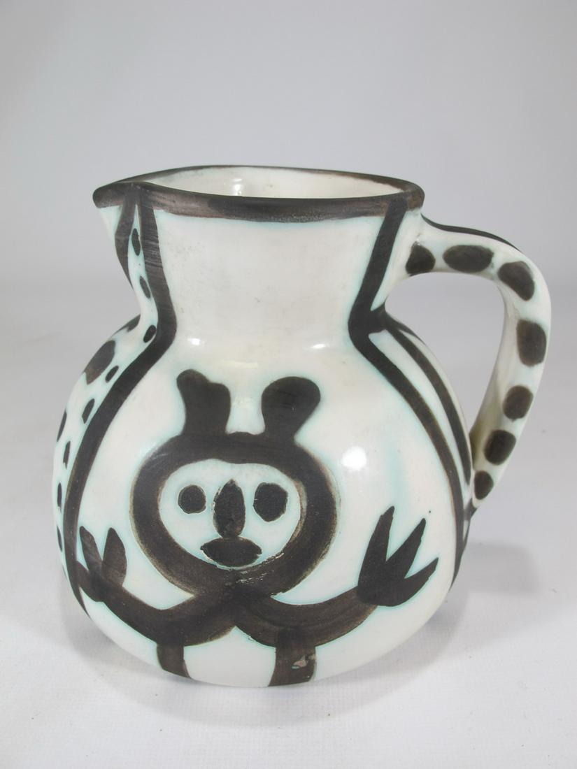 PABLO PICASSO (1881-1973), Pitcher: PABLO PICASSO (1881-1973), Pichet petites tetes (A.R. 222), stamped, marked and numbered Edition Picasso/Madoura Plein Feu/Edition Picasso/133/300 (underneath), earthenware ceramic pitcher with black 