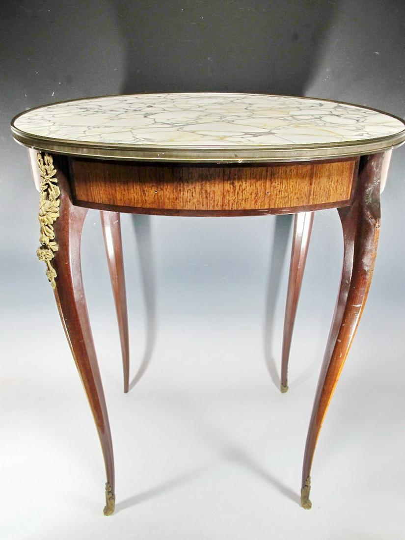 Antique French Louis XV style marble top oval table: Antique French Louis XV style marble top oval table with bronze details. 29" H x 23 1/4” W x 18 3/8” D. Shipping in USA or International please contact for quote both UPS stores: 1) : Davi