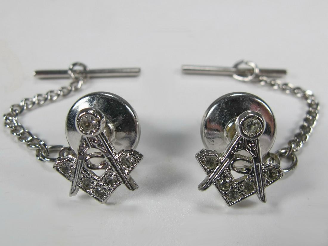 Pair of Anson Masonic Sterling cufflinks: Pair of Anson Sterling cufflinks with Freemasonry symbol embellished with white stones (?) and a short chain. Weight: 10 grams (0t oz 6.430149 dwt). Shipping in USA or International please contact for