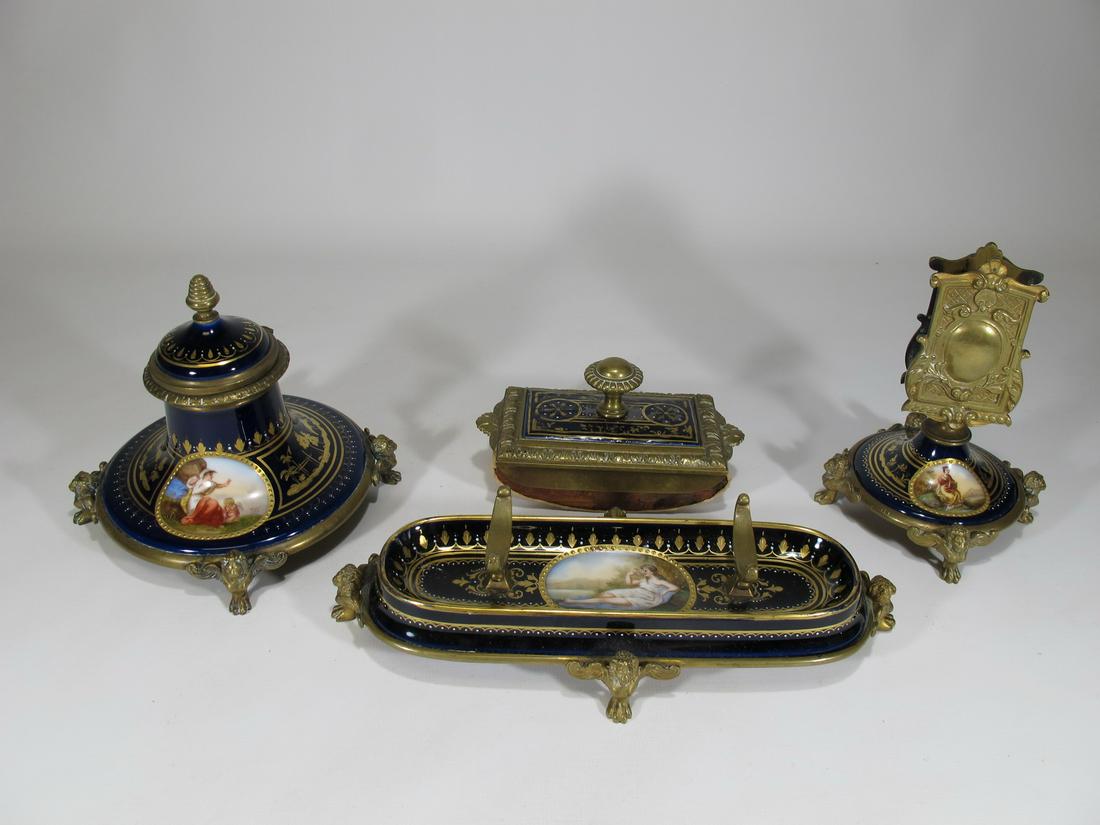 Antique Old Vienna bronze & porcelain desk set: Antique Old Vienna bronze & porcelain desk set. Inkwell: 5” H x 5 7/8” W. Blotter; 2 1/2” H x 4 7/8” W x 2 7/8” D. letter stand: 5 1/4” H x 4” W. Pen stand: 2
