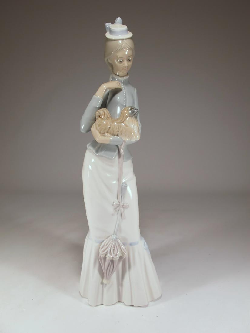 Lladro Walk with the Dog porcelain statue: Lladro Walk with the Dog porcelain statue. Issued in 1974. Retired in 2004. Sculpted by Jose Roig. 14 3/4 in h x 4 1/2 in W x 4 3/8 in D. Shipping in USA or International please contact for quote both