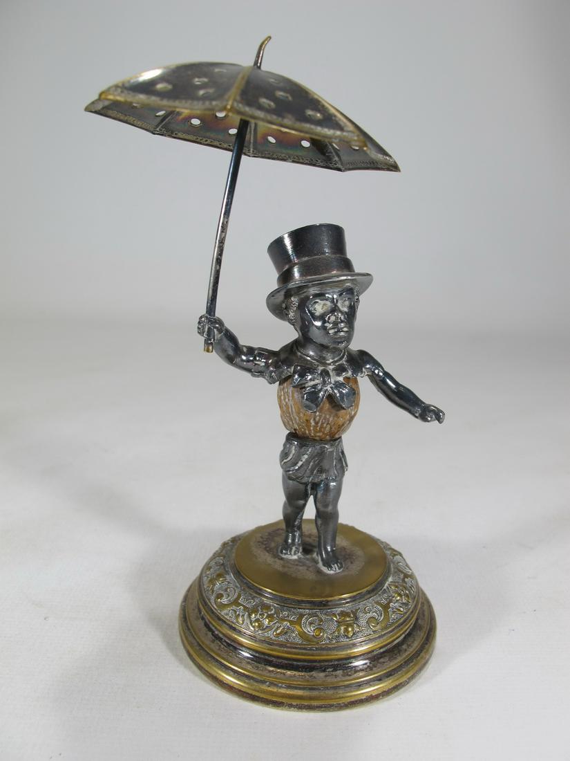 Man with an umbrella silverplated toothpick holder: Man with an umbrella silverplated toothpick holder. 5 1/8” H x 3 1/8” W x 2 5/8” D. Shipping in USA or International please contact for quote both UPS stores: 1) : David Reiser UPS s