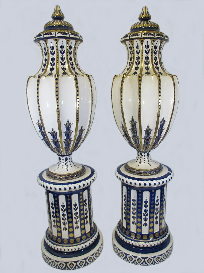 Antique Palace large Sarreguemines pair of urns with: Antique Palace large Sarreguemines pair of urns with pedestals. Urn: 38” H x 17 1/4” W without the lid, Lid: 7 1/2” H x 10 1/2” W and Base: 26 1/4” H x 19” W. Total