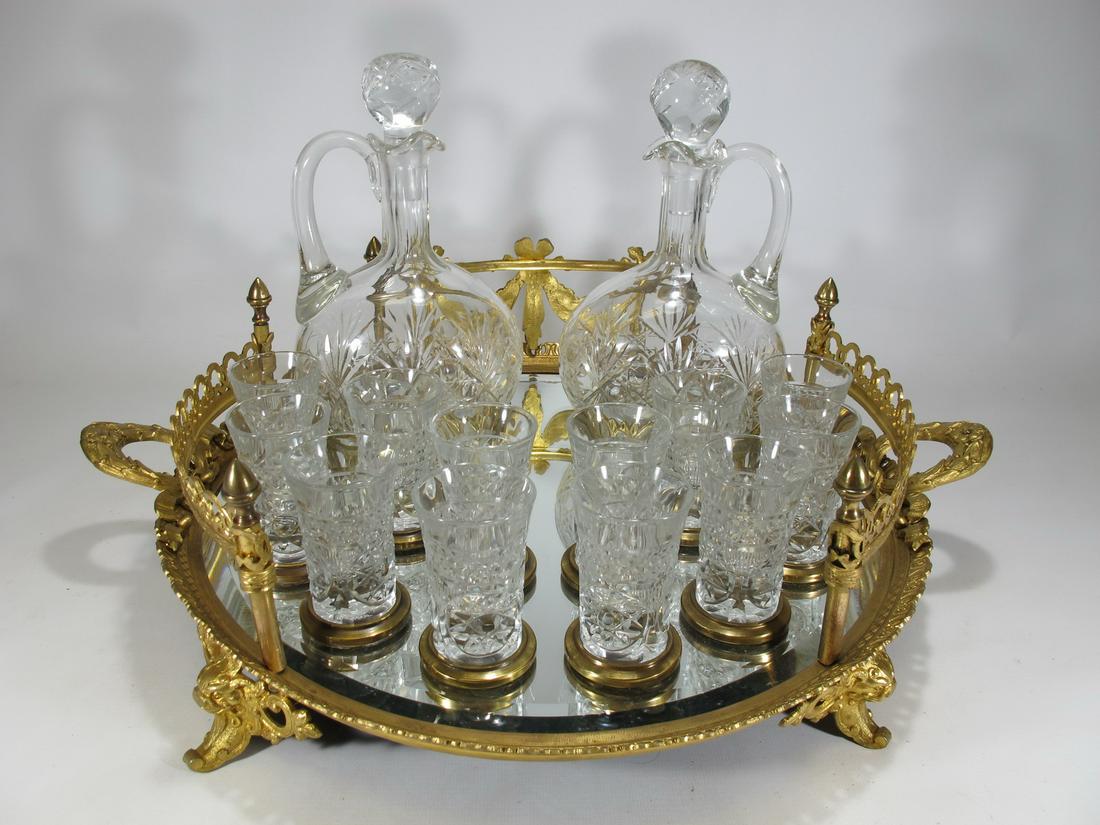 19th C french gilt bronze & Italian crystal liquor set: 19th C french gilt bronze & Italian crystal liquor set, 2 bottles & 12 goblets. Bottles: 8 3/8” H x 4 3/4” W x 3 1/4” D. Tray: 5 3/8” H x 18 3/8” diameter. Goblets: 2 3/4