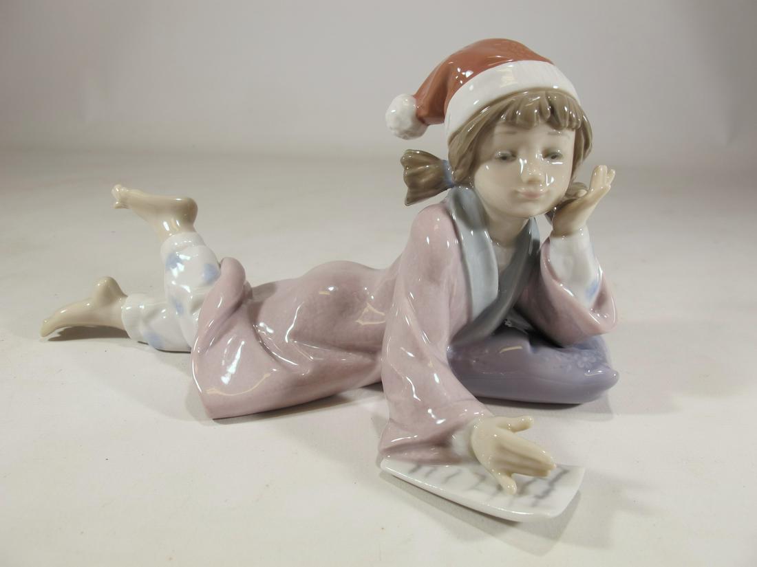 Lladro 6194 Christmas Wishes porcelain statue: Lladro 6194 Christmas Wishes porcelain statue, by Antonio Ramos and with the original box. 4 1/8” H x 7 3/4” W x 4 5/8” D. Box: 5 7/8” H x 7 1/2” W x 12 1/2” D. Shi