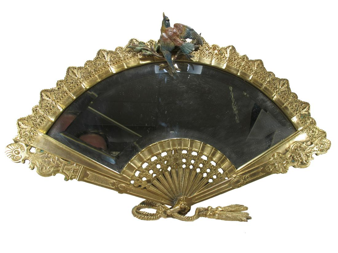 Antique gilt bronze & beveled glass fan mirror: Antique gilt bronze & beveled glass fan mirror. 12” H x 18 3/4” W x 2 3/4” D. ANY INVOICE OVER $ 2,000.00 WE WILL ACCEPT PAYMENTS ONLY THROUGH CHECK OR BANK WIRE TRANSFER, SAME FOR I
