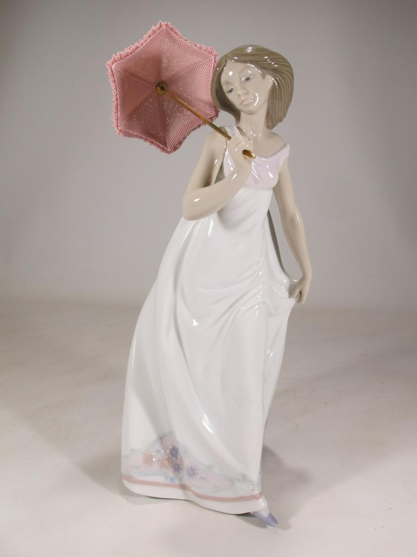 Lladro 7636 Afternoon Promenade porcelain statue: Lladro 7636 Afternoon Promenade porcelain statue, Sculpted by Jose Puche and with the original box. 9 3/4” H x 4 1/4” W x 4 1/4” D. Box: 5 3/4” H x 12 3/4” W x 7 1/2&rdqu