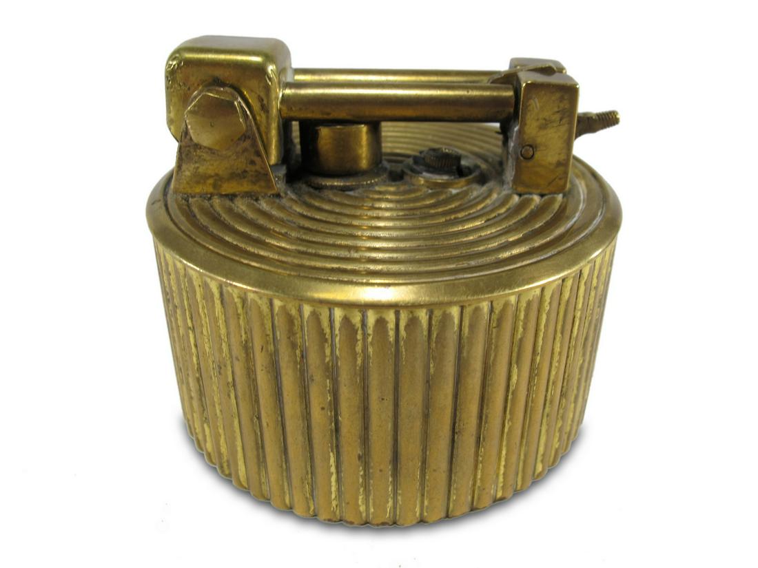 Antique Brilux Swiss table lighter: Antique Brilux Swiss table lighter. 2 1/4” H x 2 7/8” W. ANY INVOICE OVER $ 2,000.00 WE WILL ACCEPT PAYMENTS ONLY THROUGH CHECK OR BANK WIRE TRANSFER, SAME FOR INTERNATIONAL BUYERS. IF YOU