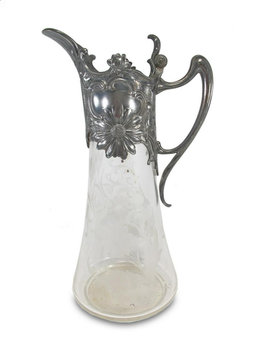 German WMF Art Nouveau metal & glass jug: German WMF Art Nouveau metal & glass jug. 12 7/8 H x 7 3/8 W x 5 1/2 D. ANY INVOICE OVER $ 2,000.00 WE WILL ACCEPT PAYMENTS ONLY THROUGH CHECK OR BANK WIRE TRANSFER, SAME FOR INTERNATIONAL BUYERS. IF 