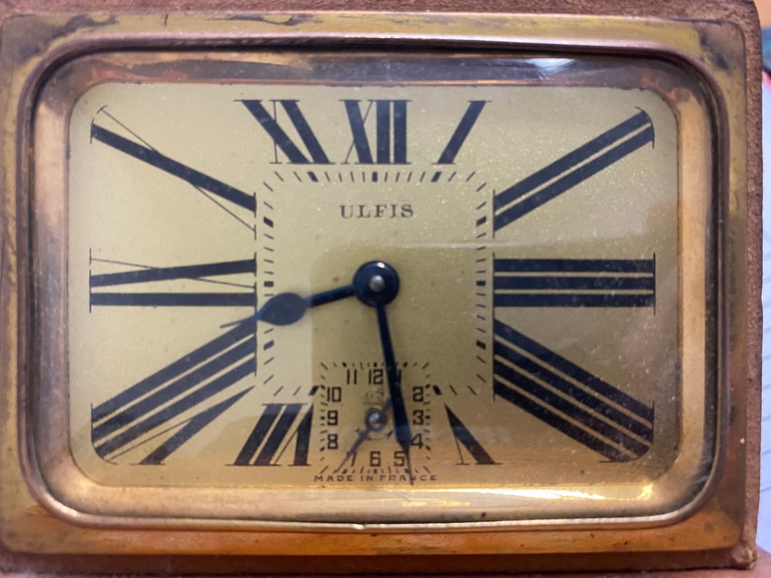 Vintage French Ulfis Clock in a Leather Bag: Vintage French Ulfis Clock in a Leather Bag. Bag: 3 1/2 x 4 x 2 3/4 in , Clock: 2 3/4 x 3 3/4 x 1 3/4 in.Local Pick up call one day before to make an appointment. TO SHIP THIS ITEM IN USA OR INTERNATI