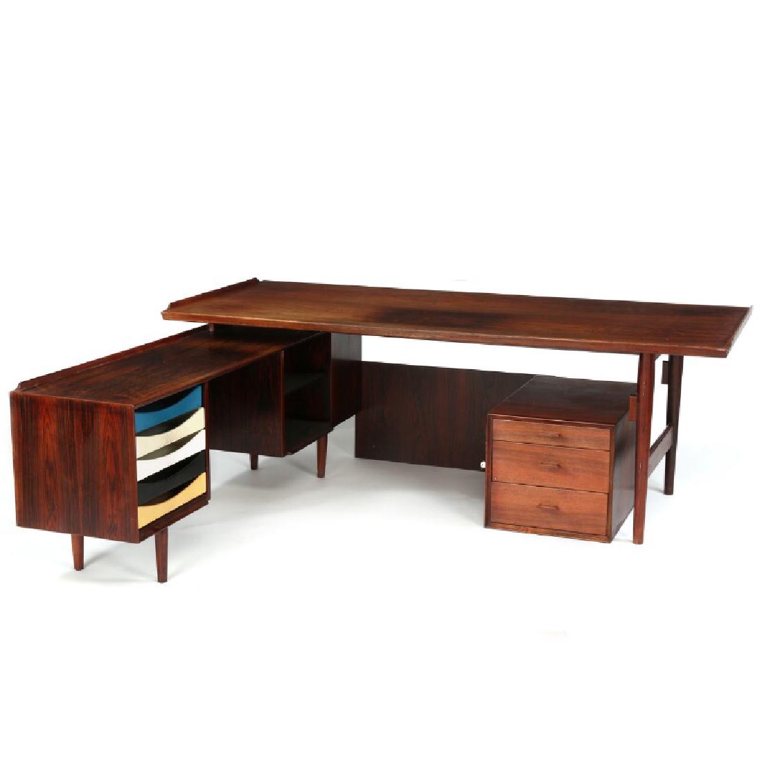 Arne Vodder: Rosewood desk with matching sideboard.: Rosewood desk with matching sideboard. Top with raised ends, drawer section with two drawers in front, one of which for files. Sideboard with shelves and five pull-out trays with polychrome lacquer, r