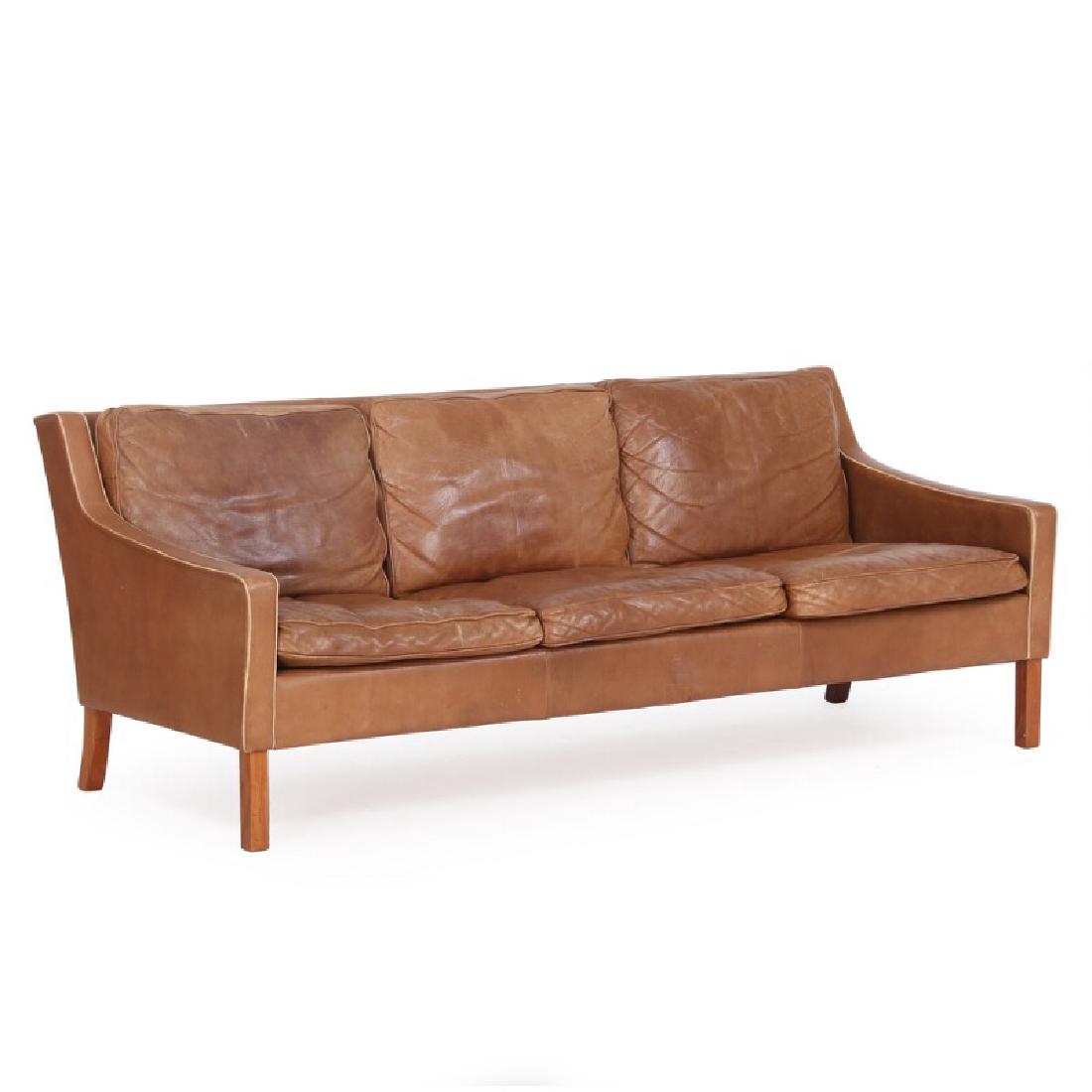 Ingemar Thillmark: Three seater sofa with legs of nut: Freestanding three seater sofa with legs of nut wood. Cushions, back and sides upholstered with brown coloured leather. Manufactured by OPE. Retailed by Illums Bolighus with plaquette. H. 71 cm.. L. 1