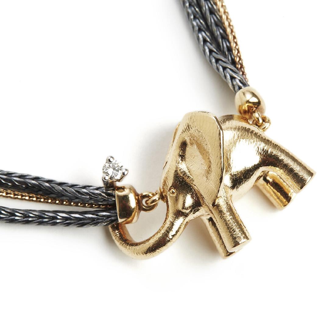 Ole Lynggaard: A three-strand necklace with a diamond: A three-strand necklace with a diamond clasp in the shape of an elephant set with a brilliant-cut diamond weighing app. 0.10 ct., mounted in 14k gold and oxidized silver. Colour: Top Wesselton (G). Cl