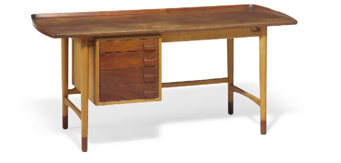 Arne Vodder: Freestanding beech desk with teak "shoes".: Freestanding beech desk with teak "shoes". Top with raised edges, drawers, cabinet door and pull-out leaf of teak. Drawer section with four drawer in front, reverse side with cabinet, interior with st