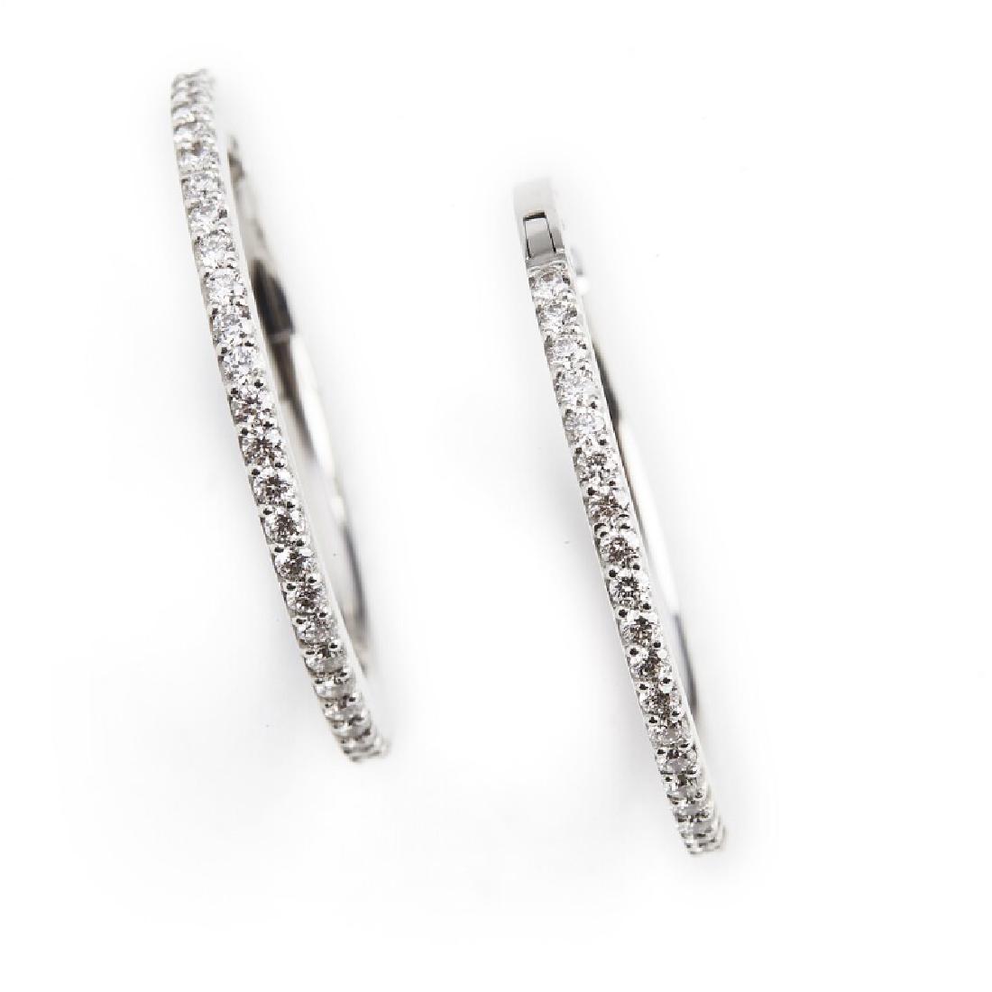 Ole Lynggaard: A pair of diamond ear pendants "Creoles": A pair of diamond ear pendants "Creoles" each set with numerous brilliant-cut diamonds weighing a total of app. 0.41 ct., mounted in 18k white gold. Colour: Top Wesselton (G). Clarity: VS. Diam. app.