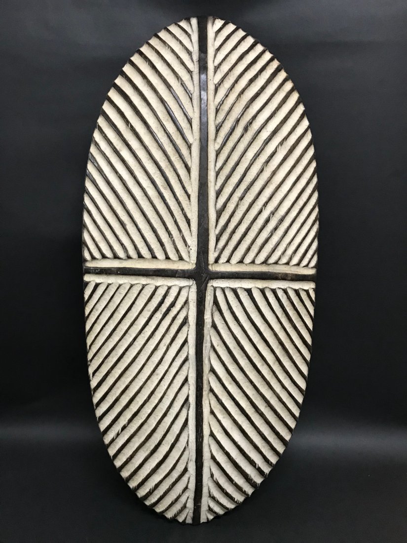 Zulu Shield: African Art Zulu Shield from South Africa. The dimension is 25.75 inches high x 12 inches wide. The packing and shipping cost with insurance for domestic is $45.00 flat rate shipping within the Contin