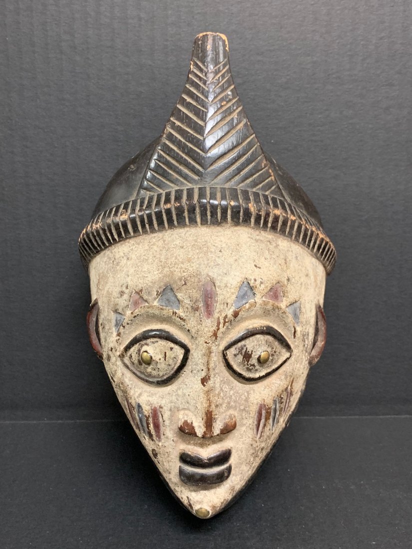 Yoruba Mask: African Tribal Art Yoruba Mask from Nigeria. The dimension 10 inches high x 6 inches wide. The packing and shipping cost with insurance for domestic is $25.00 flat rate shipping within the Continental