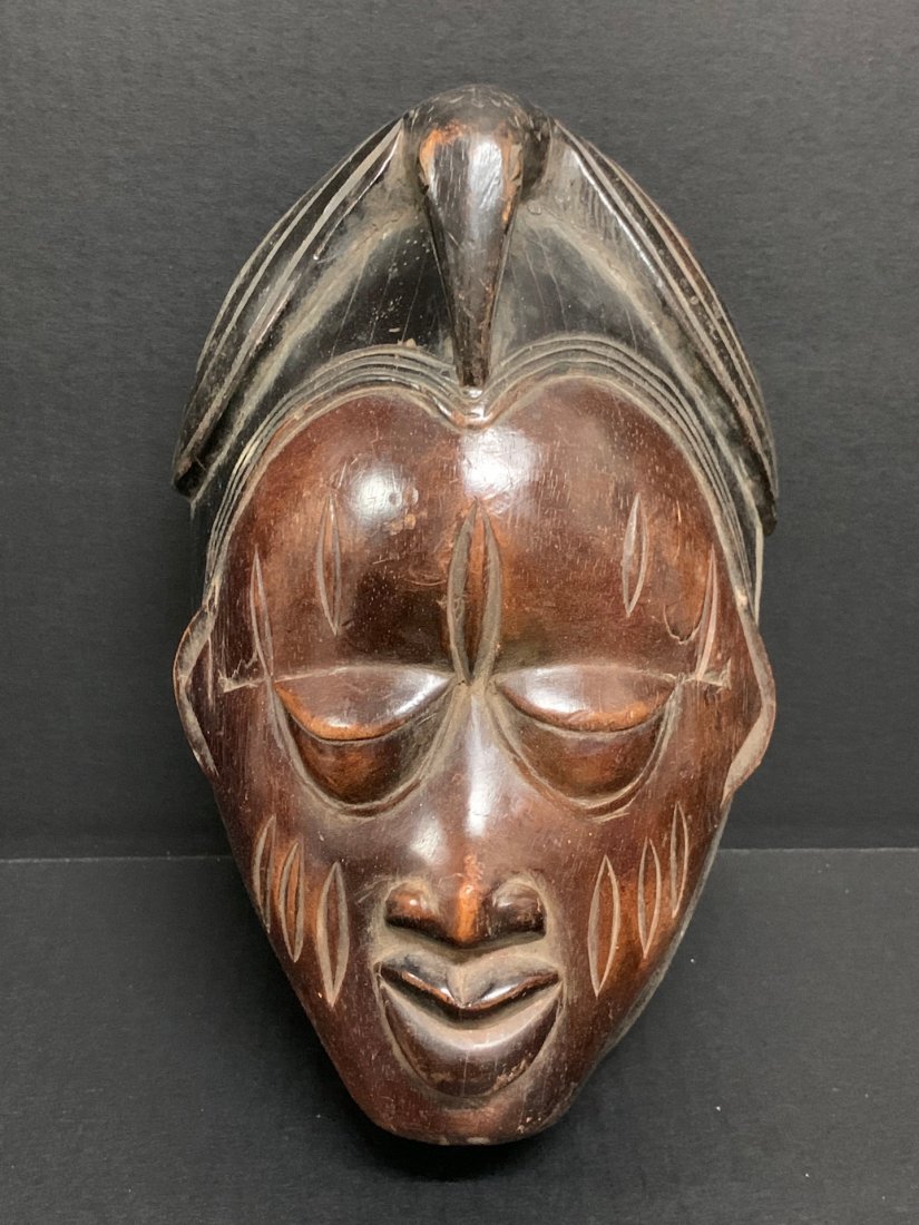 Yoruba Mask: African Tribal Art Yoruba Mask from Nigeria. The dimension 10 inches high x 7 inches wide. The packing and shipping cost with insurance for domestic is $40.00 flat rate shipping within the Continental