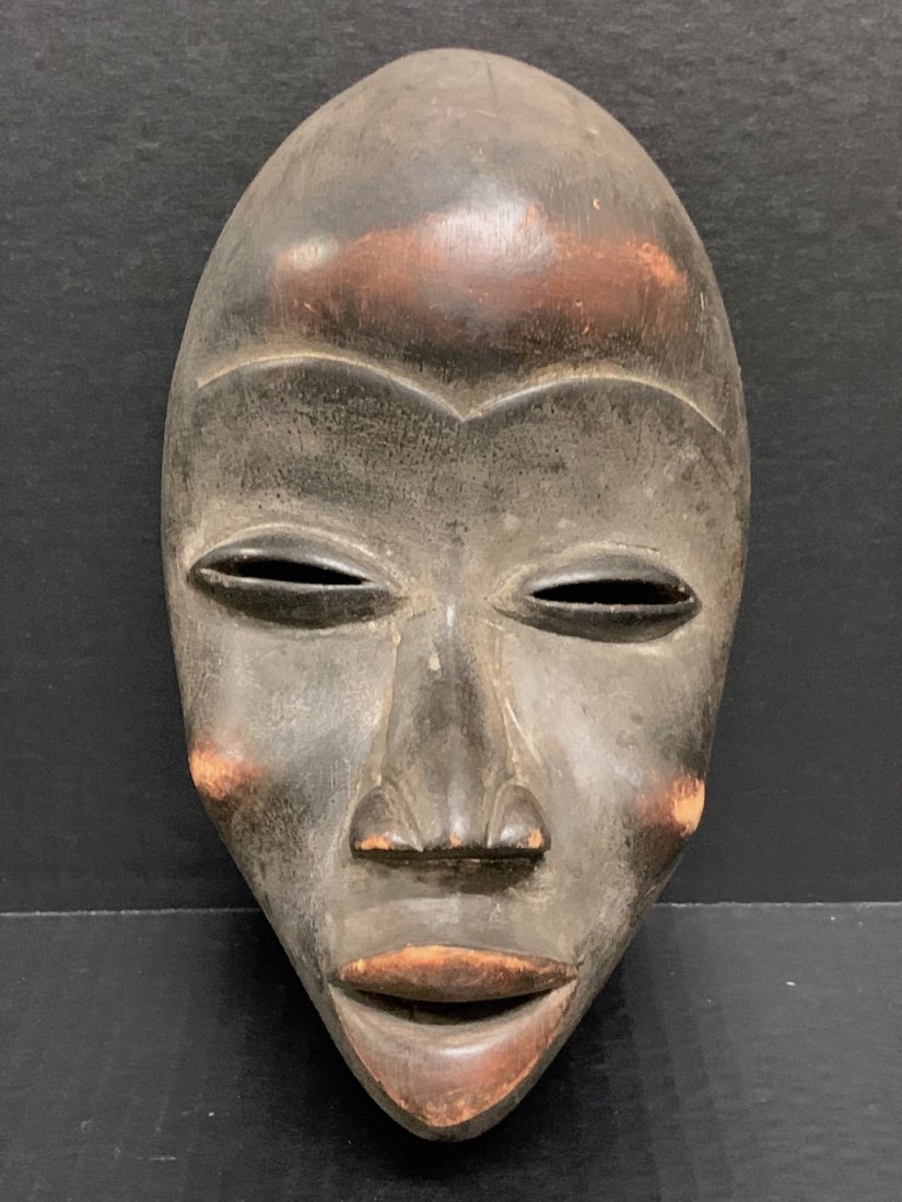 Dan Mask: African Art Dan Mask from Ivory Coast. The dimension is 10 inches high x 5 inches wide. The shipping cost for domestic is $45.00 flat rate shipping within the Continental US including handling, packin