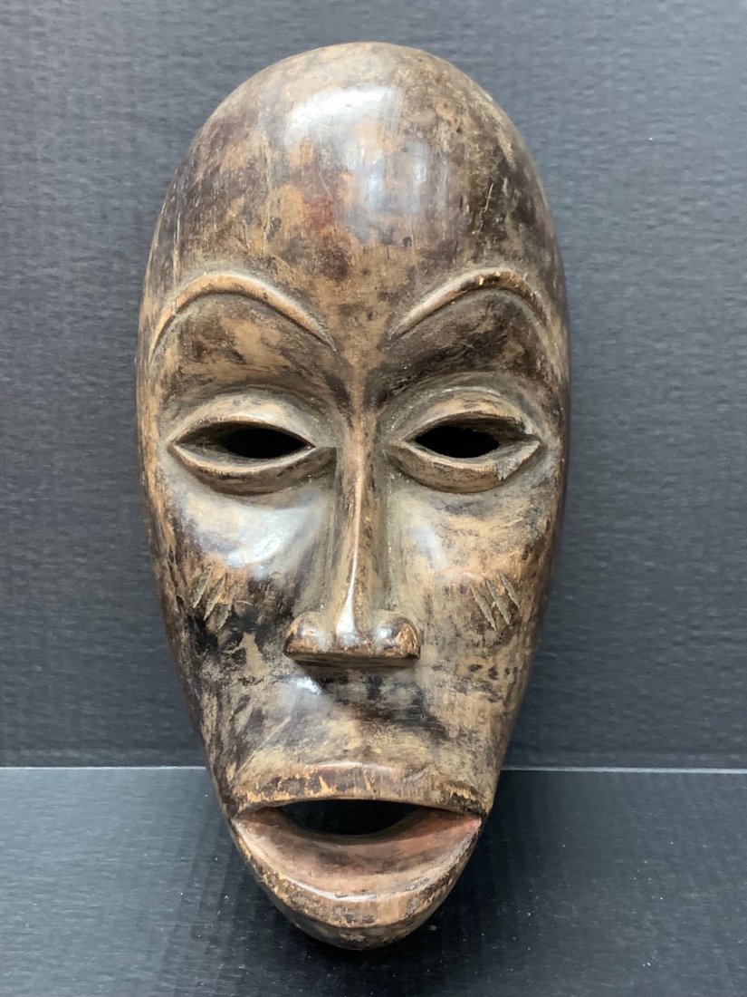 Dan Mask: African Art Dan Mask from Ivory Coast. The dimension is 14 inches high x 8 inches wide. The shipping cost for domestic is $45.00 flat rate shipping within the Continental US including handling, packin