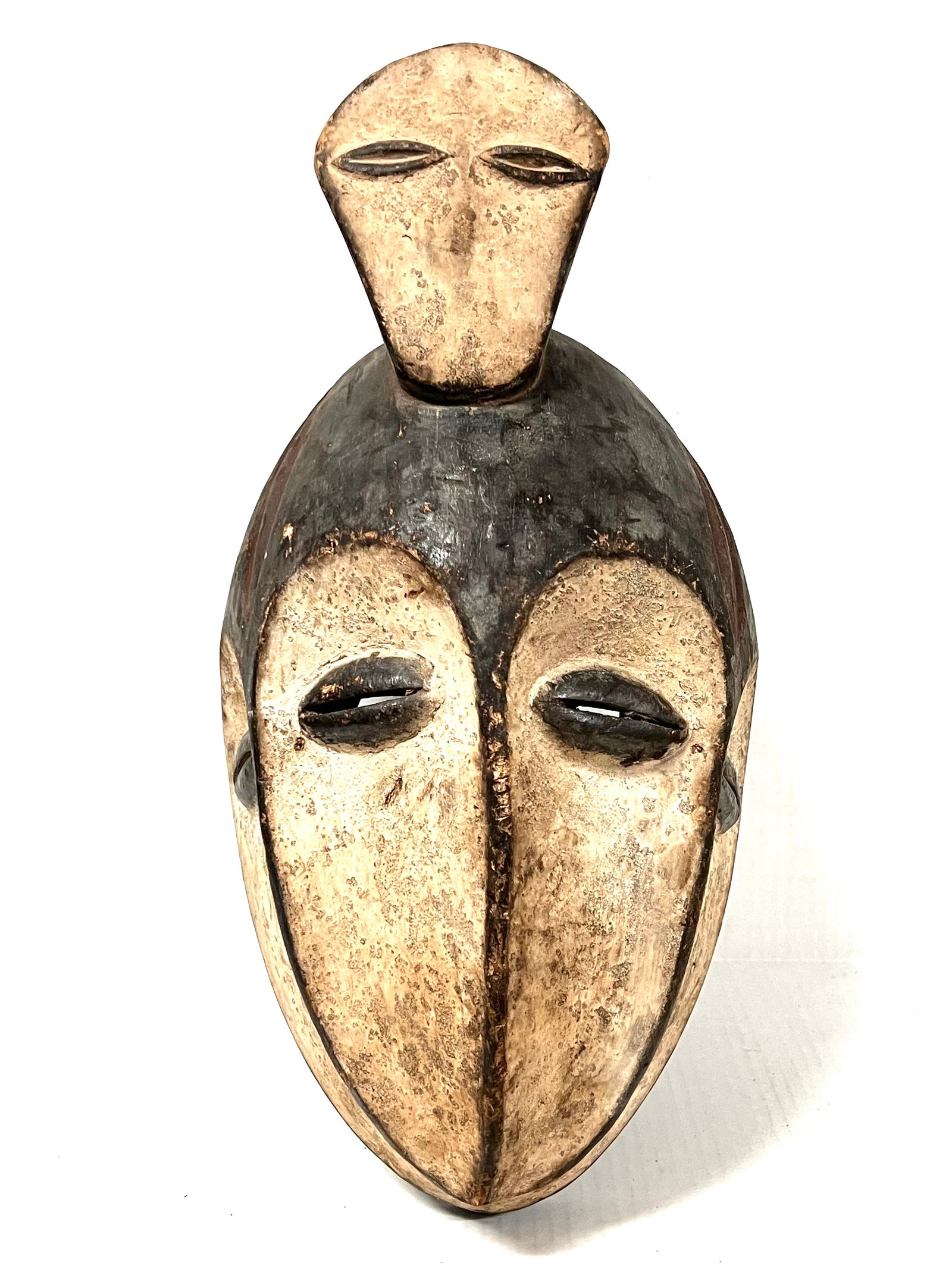 Kwele Mask: African Tribal Art Kwele Mask. The dimension is 15 inches high x 9 inches wide. Please be aware that some of the items are vintage, secondhand, old ages, antiques and may have a defects or sign of age