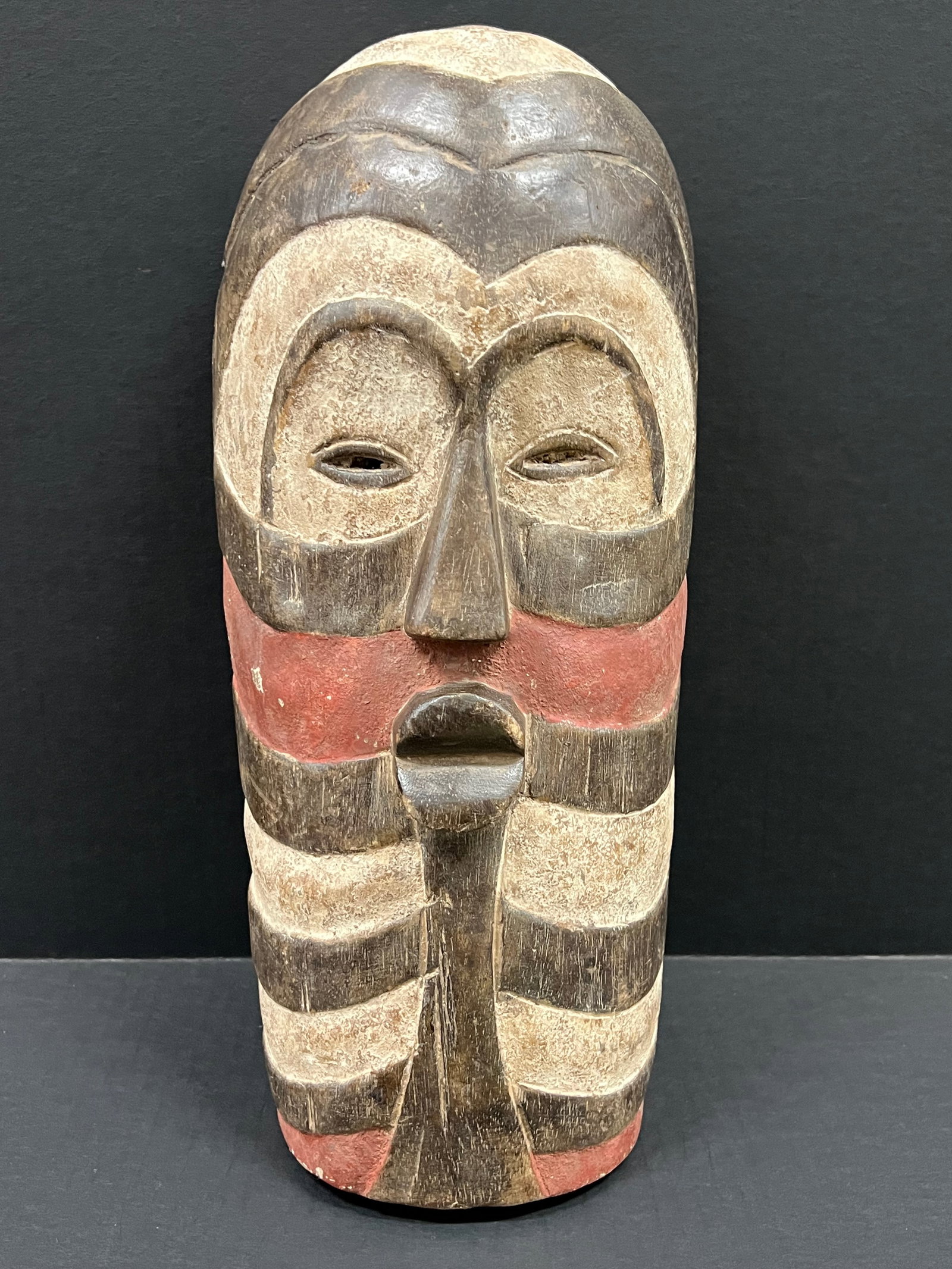 Songye Mask: African Tribal Art Songye Mask. The dimension is 16 inches high x 7.5 inches wide. Please be aware that some of the items are vintage, secondhand, old ages, antiques and may have a defects or sign of 