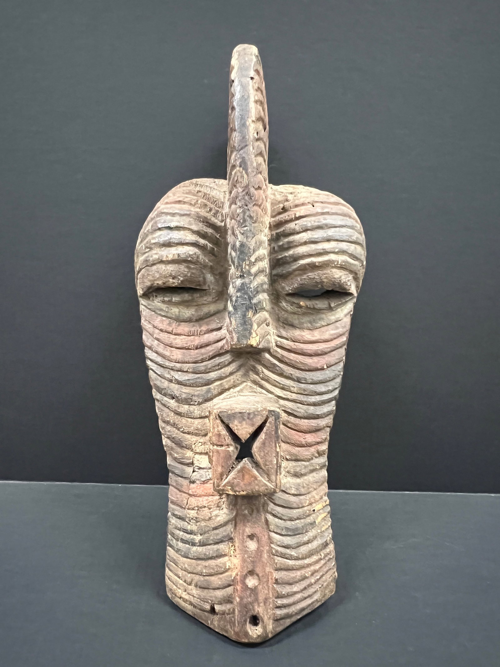 Songye Mask: African Tribal Art Songye Mask. The dimension is 20 inches high x 9 inches wide. Please be aware that some of the items are vintage, secondhand, old ages, antiques and may have a defects or sign of ag