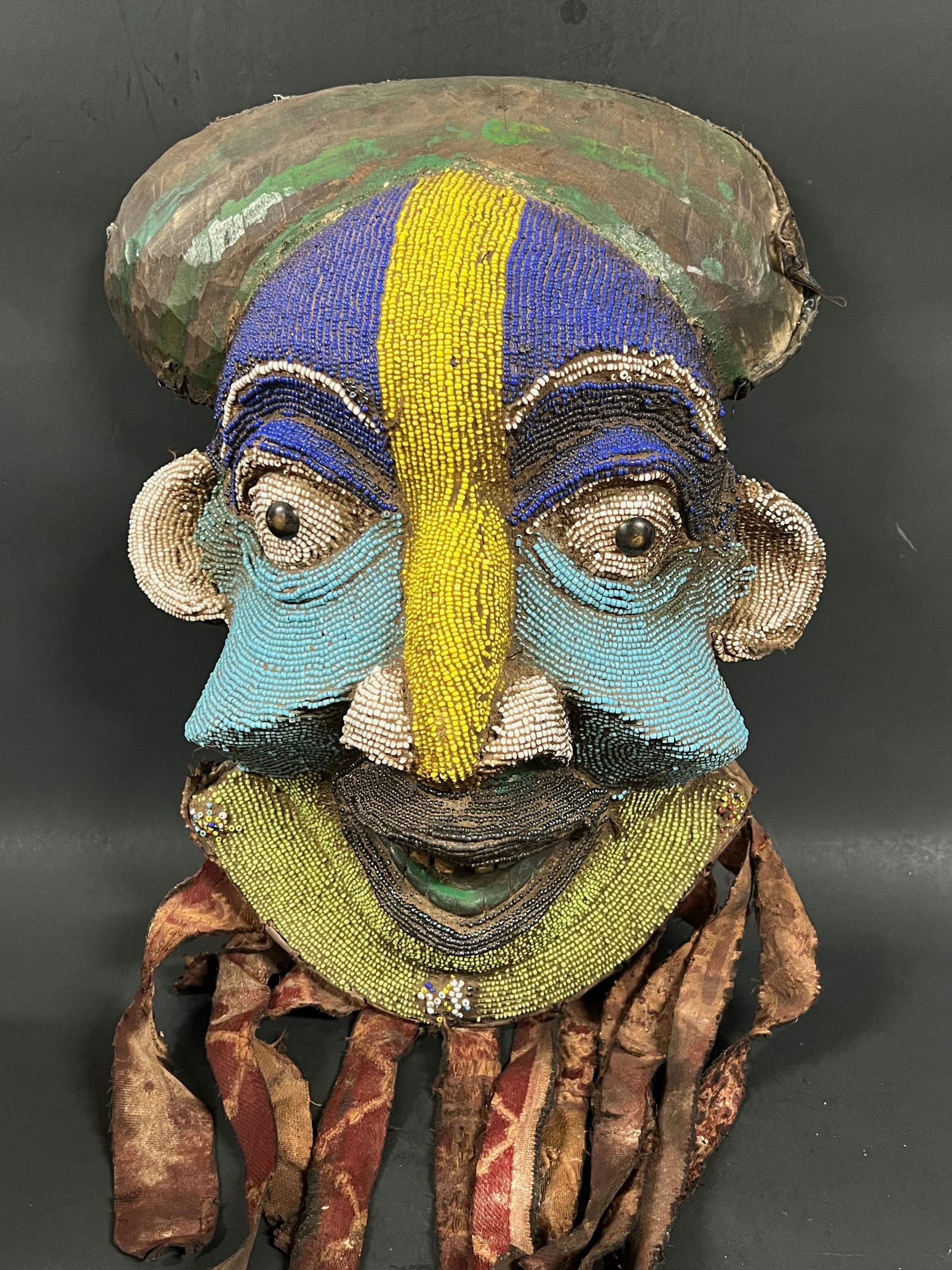 Bamileke Beaded Mask: African Tribal Art Bamileke Beaded Mask. The dimension is 15 inches high x 12 inches wide. Please be aware that some of the items are vintage, secondhand, old ages, antiques and may have a defects or