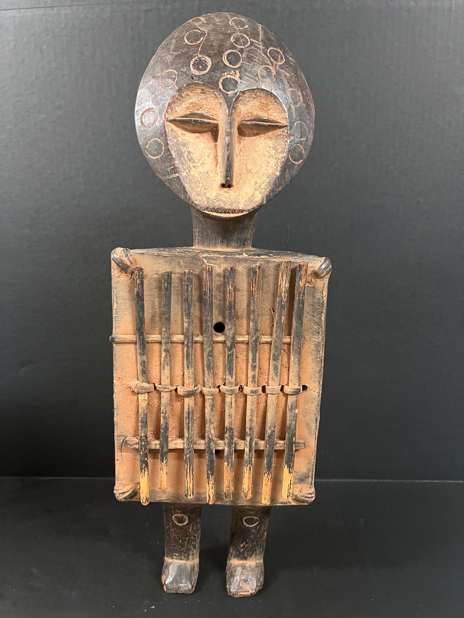 Lega Thumb Piano Instrument: African Tribal Art Lega Thumb Piano Instrument. The dimension is 21 inches high x 7 inches wide. Please be aware that some of the items are vintage, secondhand, old ages, antiques and may have a defec