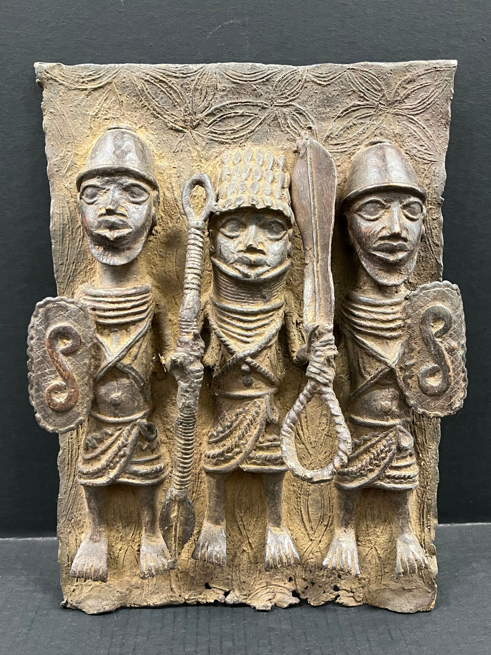 Benin Bronze Plaque: African Tribal Art Benin Bronze Plaque. The dimension is 11.5 inches high x 3 inches depth x 11 inches wide. Please be aware that some of the items are vintage, secondhand, old ages, antiques and may