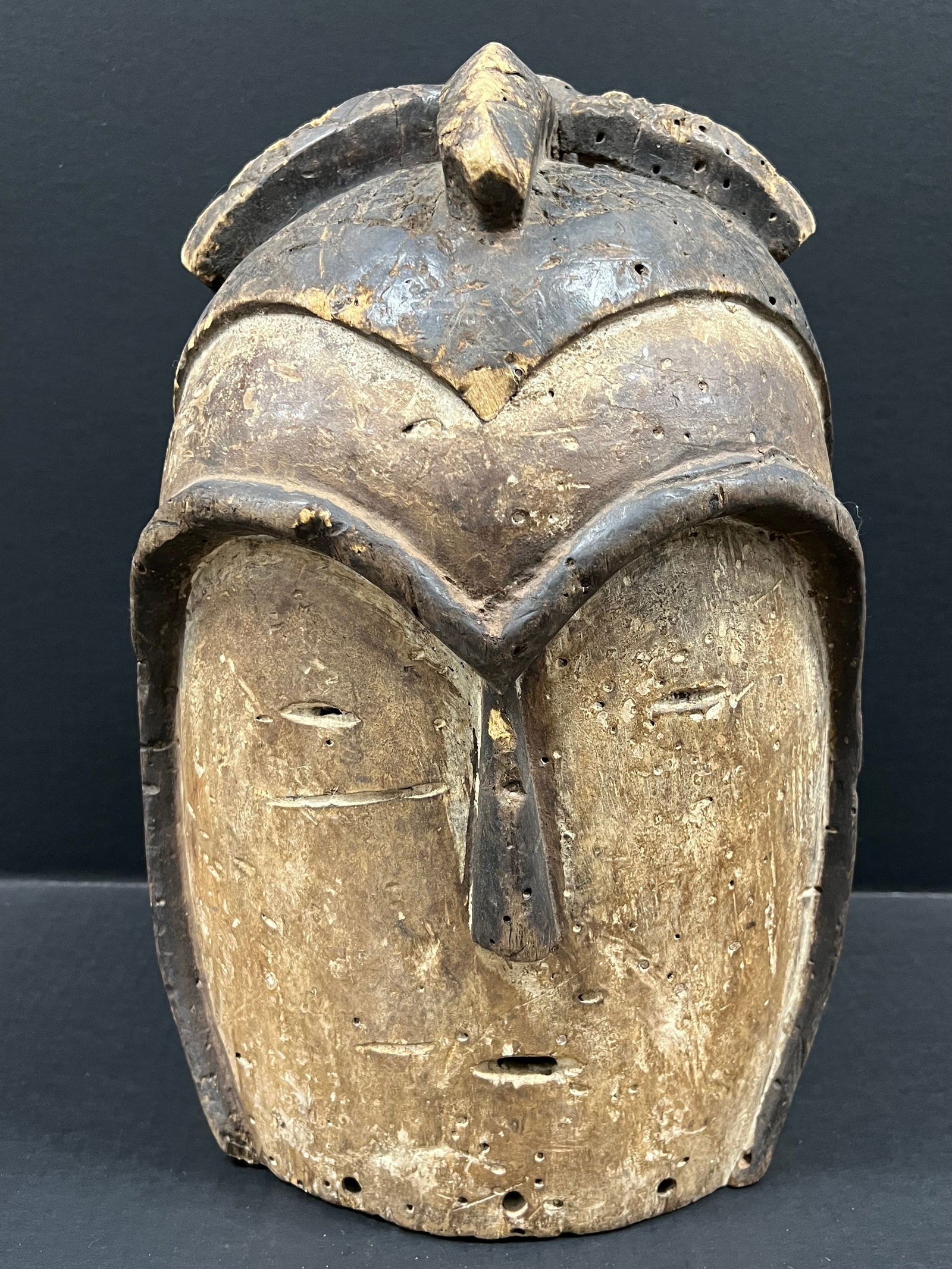 Kwele Helmet Mask: African Tribal Art Kwele Helmet Mask. The dimension is 16 inches high x 12 inches wide. Please be aware that some of the items are vintage, secondhand, old ages, antiques and may have a defects or sig
