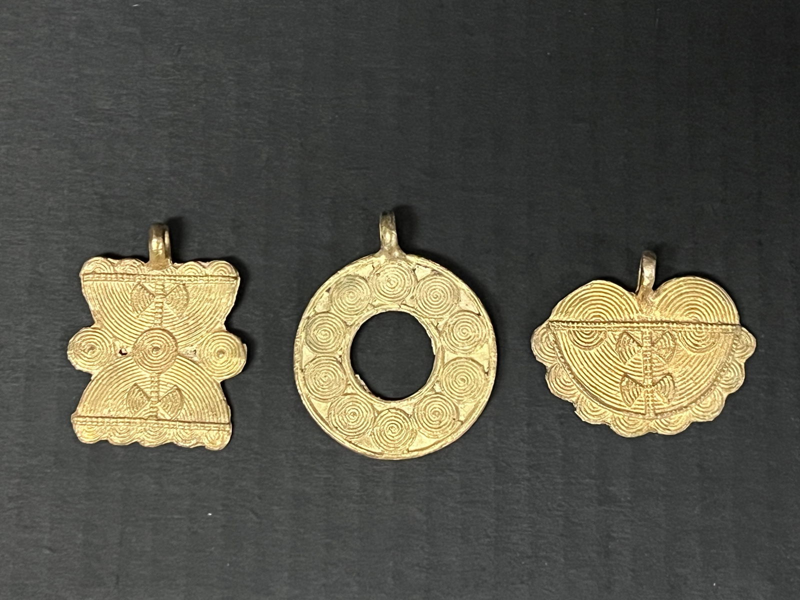 Ashanti Brass Pendant 3 pieces: African Tribal Art Ashanti Brass Pendant. The dimension is 2.5 inches high x 2 inches wide. Please be aware that some of the items are vintage, secondhand, old ages, antiques and may have a defects or