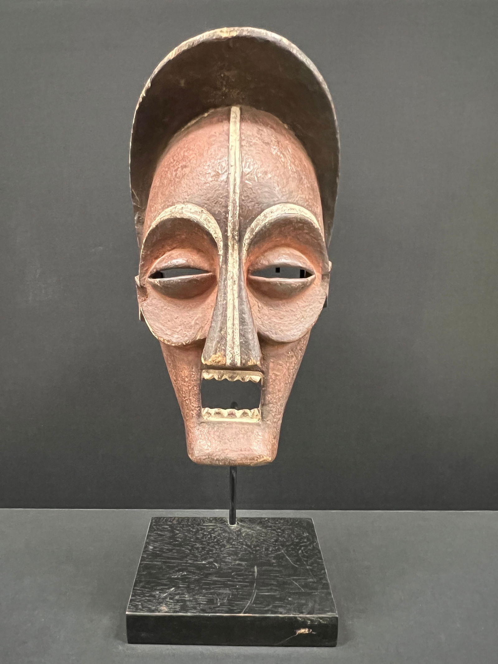 Chokwe Mask with Stand: African Tribal Art Chokwe Mask with Stand. The dimension is 20.5 inches high x 8 inches wide. Please be aware that some of the items are vintage, secondhand, old ages, antiques and may have a defects