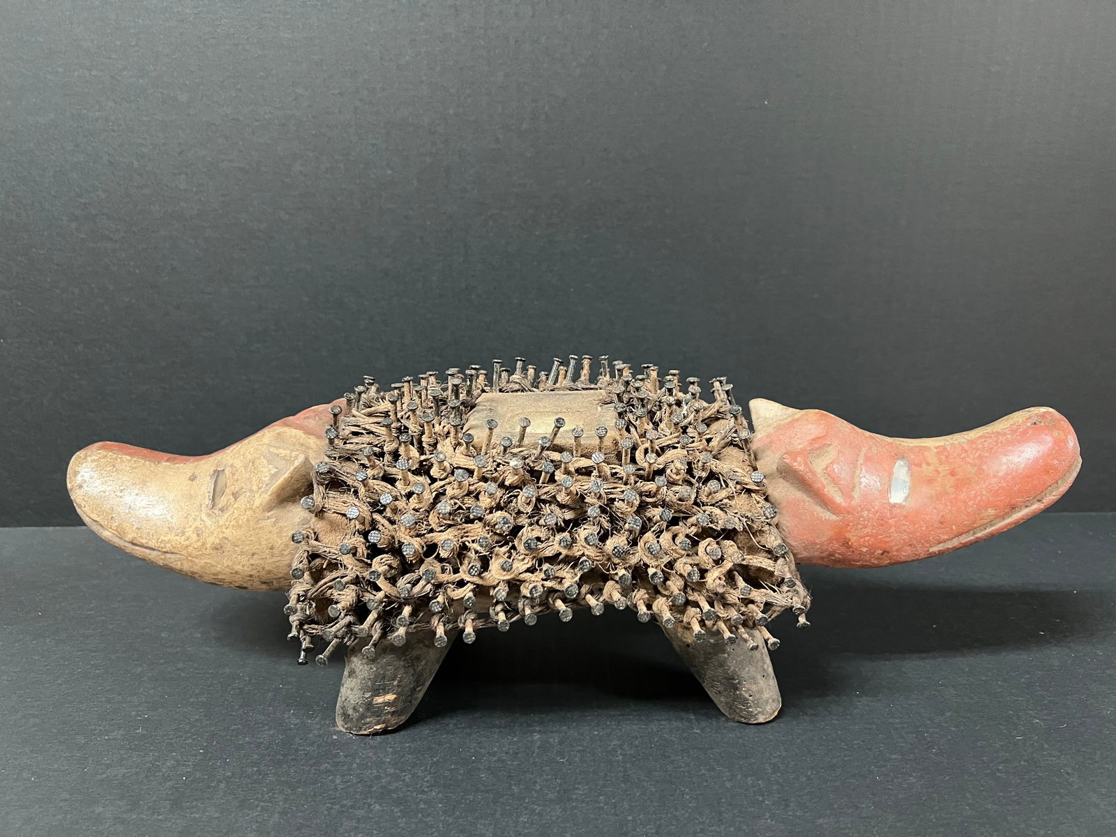 Carved Wood Bacongo Dog Fetish Double Head Statue: African Tribal Art Carved Wood Bacongo Dog Fetish Double Head Statue. The dimension is 5.5 inches high x 6 inches depth x 16 inches wide. Please be aware that some of the items are vintage, secondhand