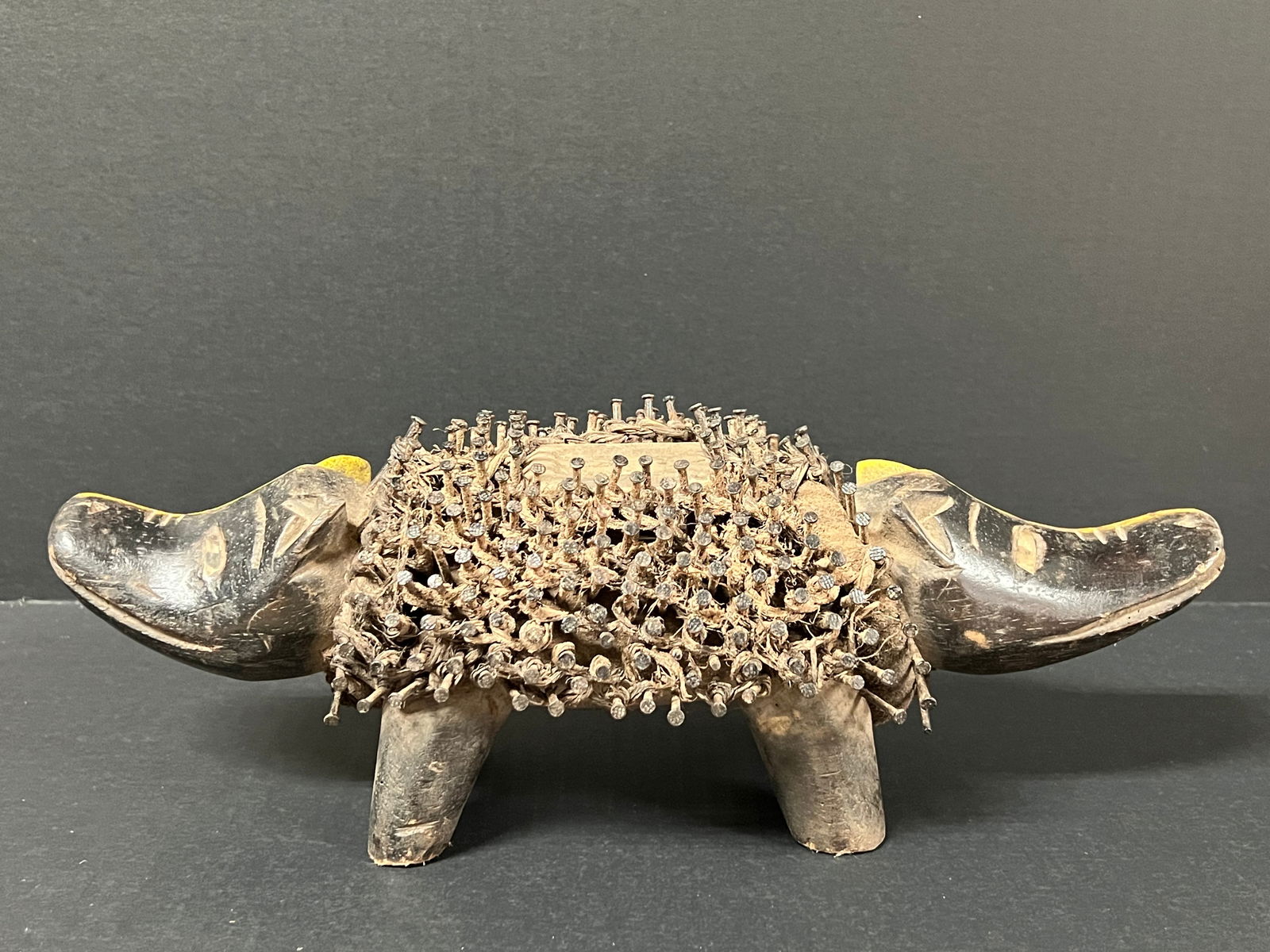 Carved Wood Bacongo Dog Fetish Double Head Statue: African Tribal Art Carved Wood Bacongo Dog Fetish Double Head Statue. The dimension is 5.5 inches high x 6 inches depth x 14.5 inches wide. Please be aware that some of the items are vintage, secondha