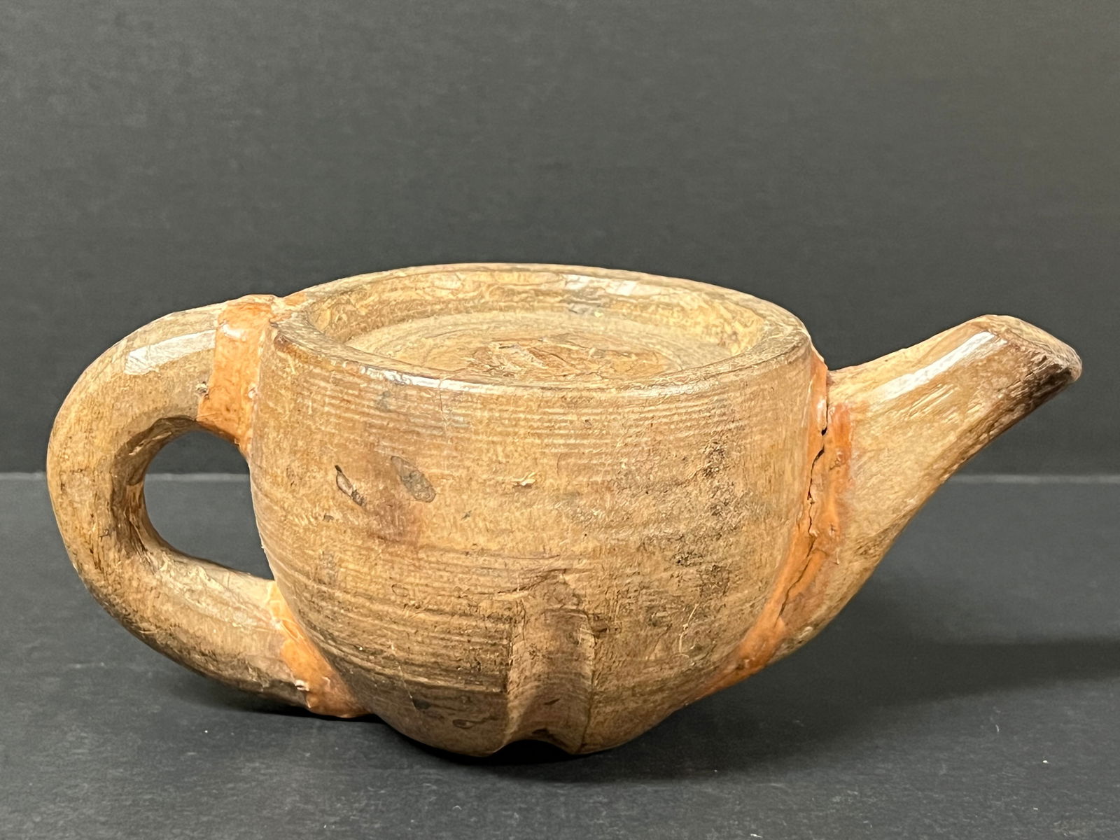 Carved Wood Teapot: Folk Art Carved Wood Teapot. The dimension is 3.5 inches high x 4.5 inches depth x 8 inches wide. Please be aware that some of the items are vintage, secondhand, old ages, antiques and may have a defe