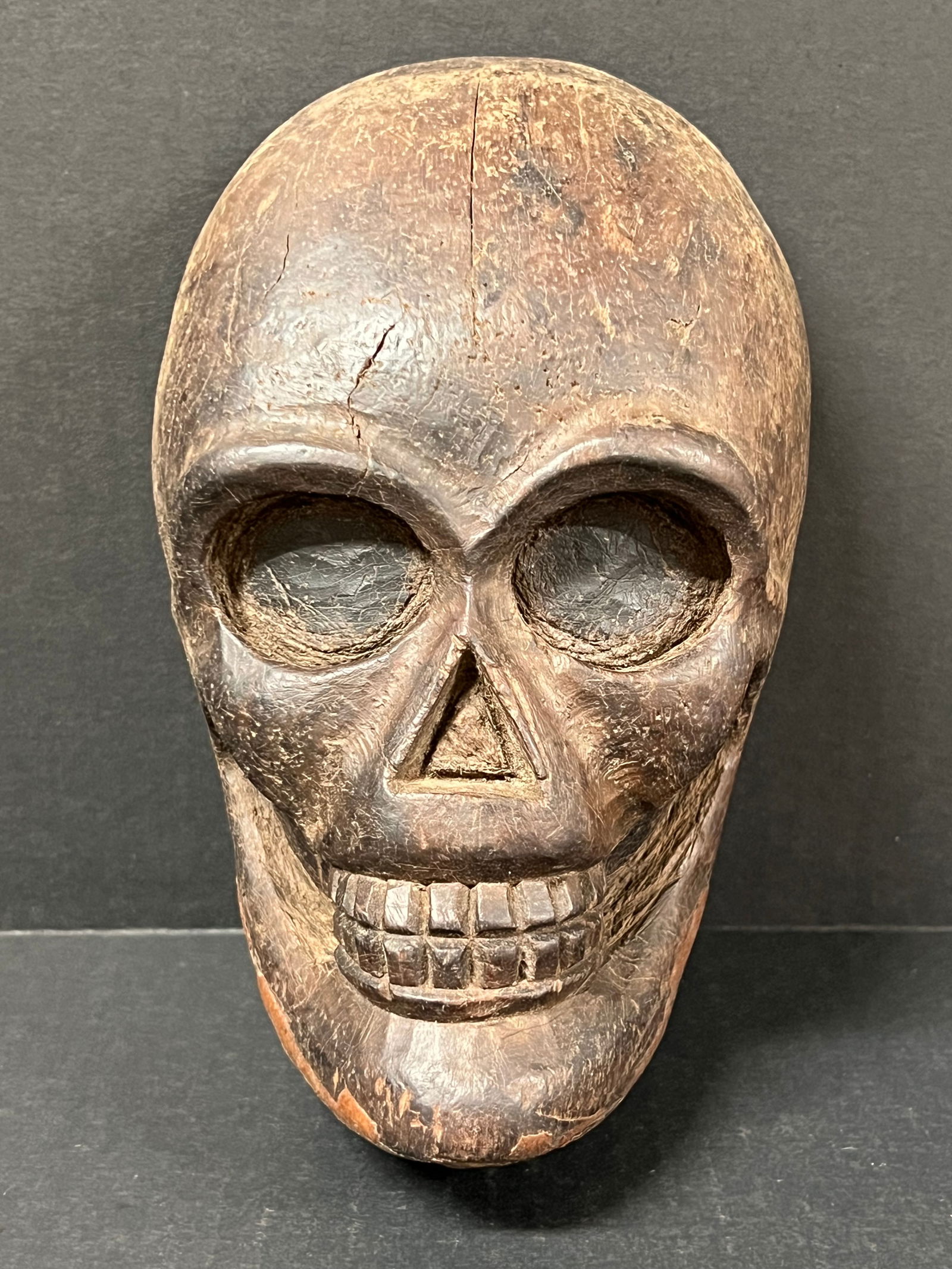 Carved Wood Skull: Folk Art Carved Wood Skull. The dimension is 8 inches high x 3 inches depth x 5 inches wide. Please be aware that some of the items are vintage, secondhand, old ages, antiques and may have a defects o
