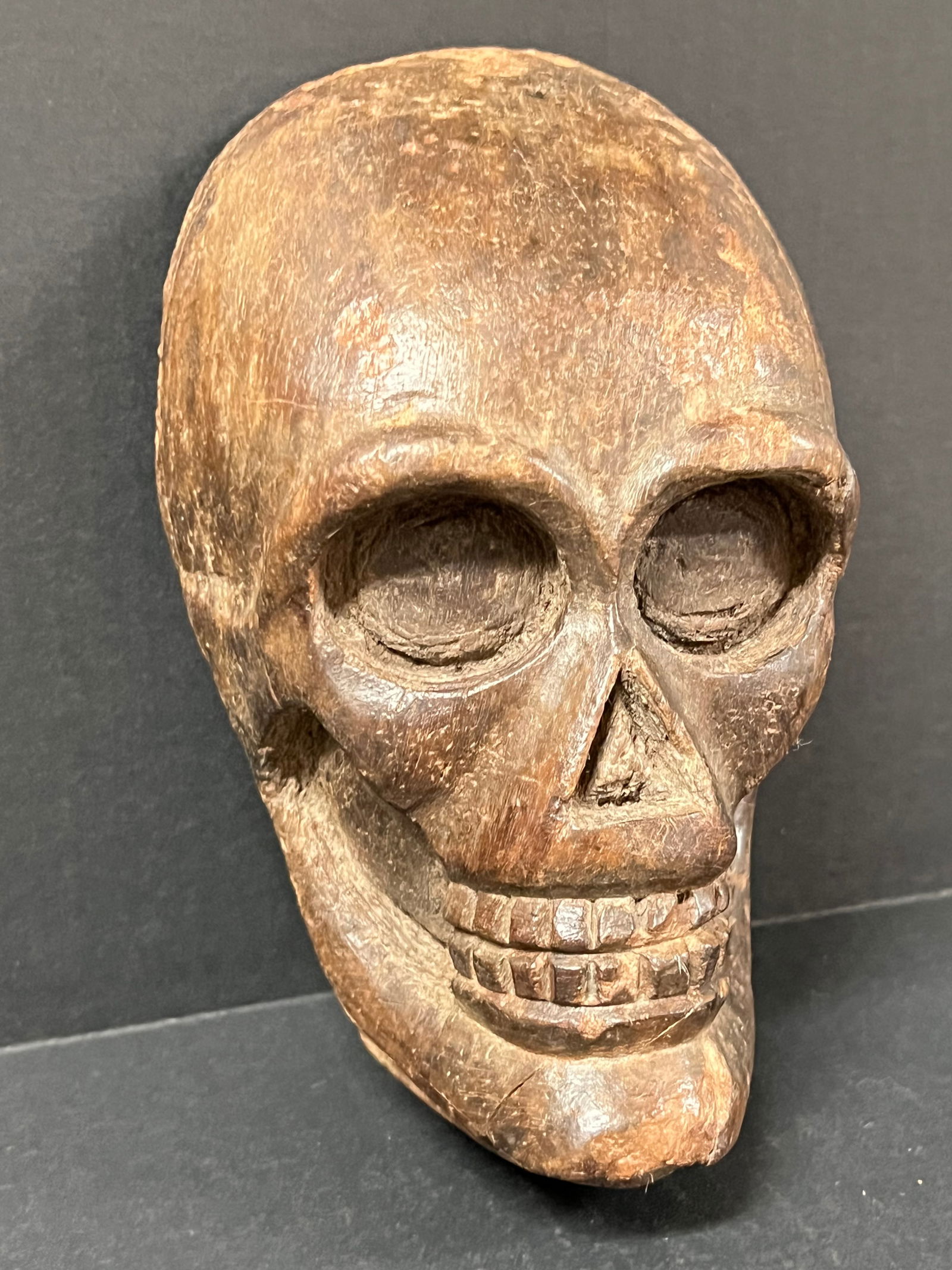 Carved Wood Skull: Folk Art Carved Wood Skull. The dimension is 8 inches high x 3 inches depth x 5 inches wide. Please be aware that some of the items are vintage, secondhand, old ages, antiques and may have a defects o
