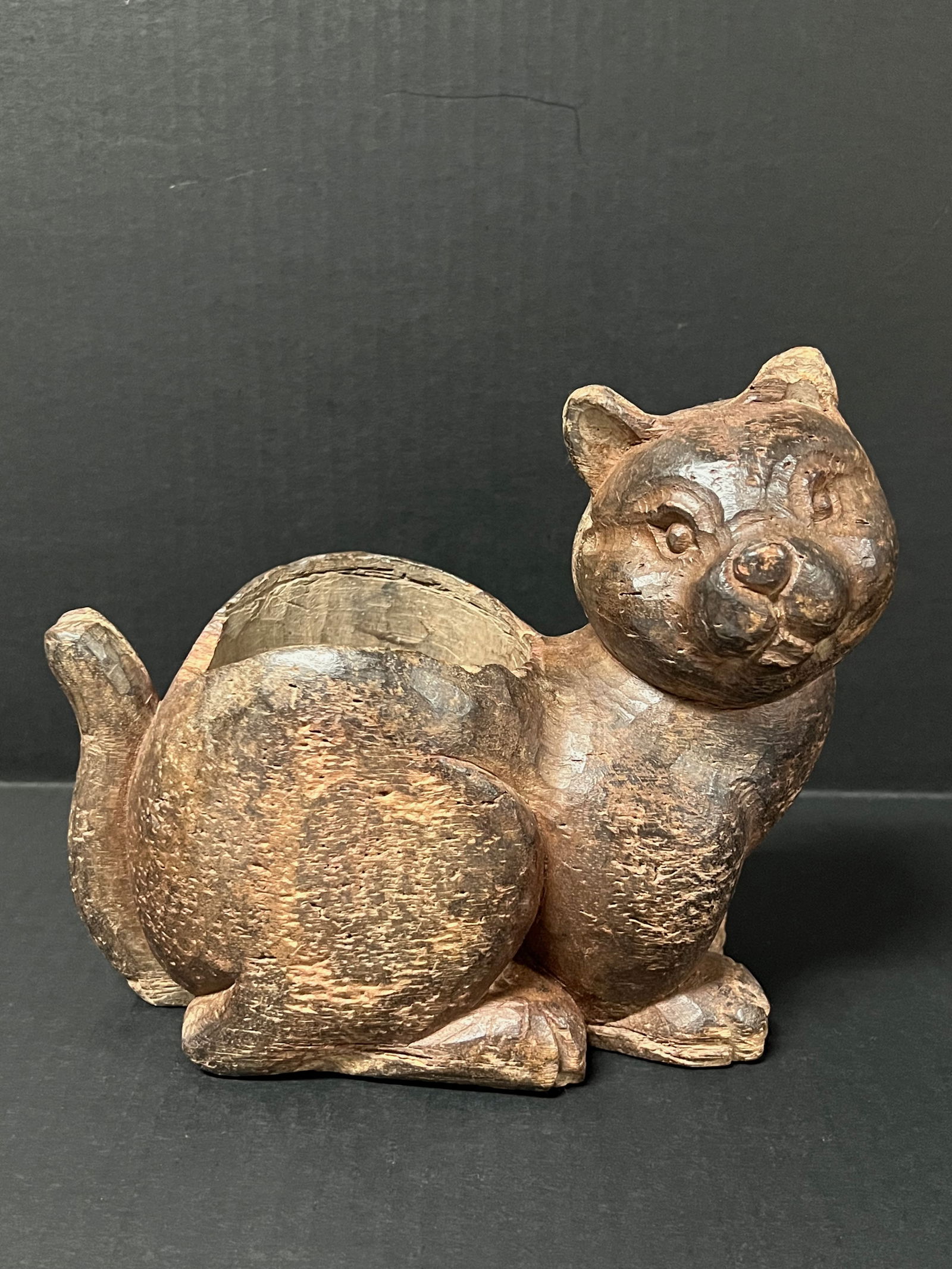 Carved Wood Cat Sculpture: Folk Art Carved Wood Cat Sculpture. The dimension is 7.75 inches high x 8 inches wide. Please be aware that some of the items are vintage, secondhand, old ages, antiques and may have a defects or sign