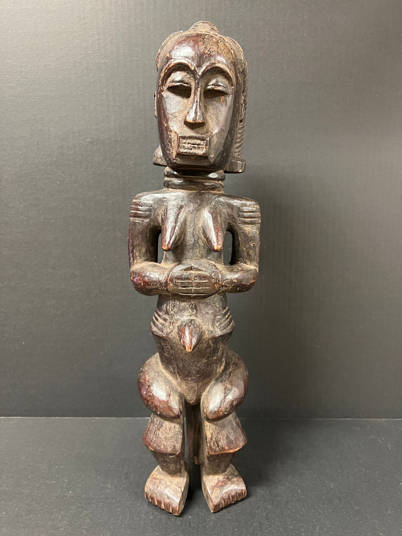 Fang Statue: African Tribal Art Fang Statue. The dimension is 19.5 inches high x 5 inches wide. Please be aware that some of the items are vintage, secondhand, old ages, antiques and may have a defects or sign of