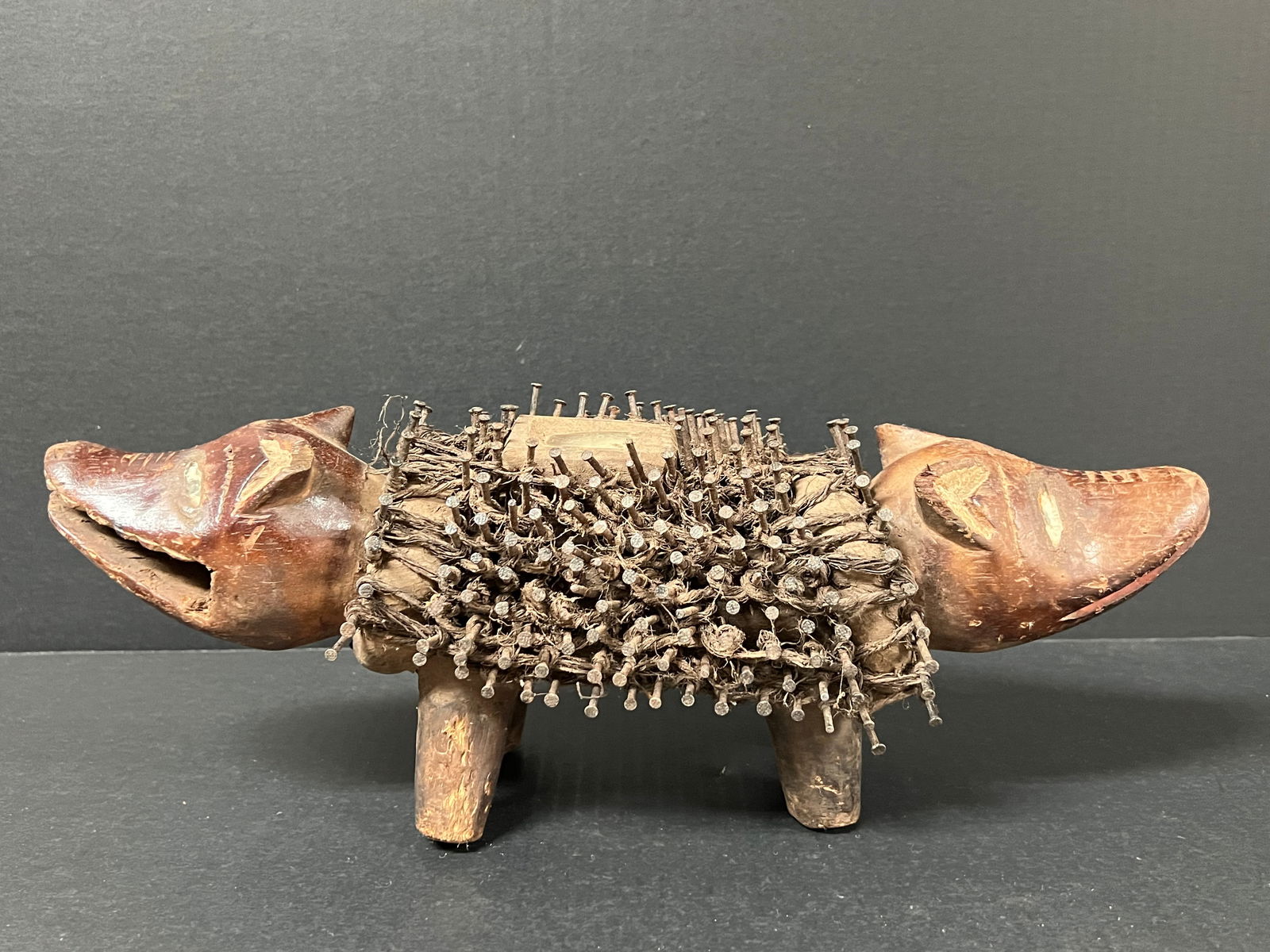 Bacongo Nail Fetish Dog Double Head Statue: African Tribal Art Bacongo Nail Fetish Dog Double Head Statue. The dimension is 6.5 inches high x 6 inches depth x 16.5 inches wide. Please be aware that some of the items are vintage, secondhand,