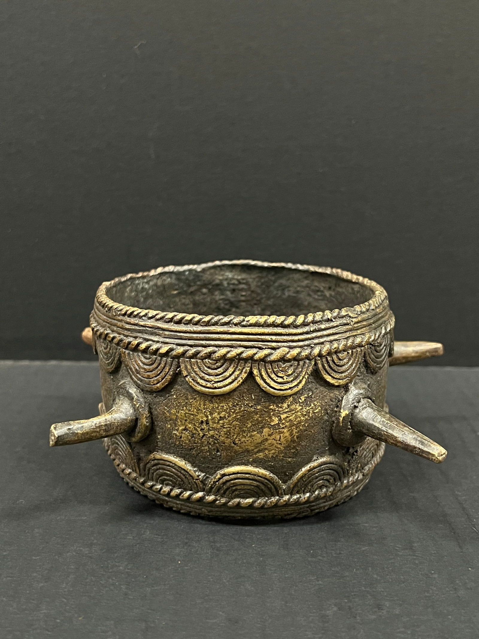 Bronze Nigerian Currency Bracelet: African Tribal Art Bronze Nigerian Currency Bracelet. The dimension is 3 inches high x 7 inches wide. Please be aware that some of the items are vintage, secondhand, old ages, antiques and may have a