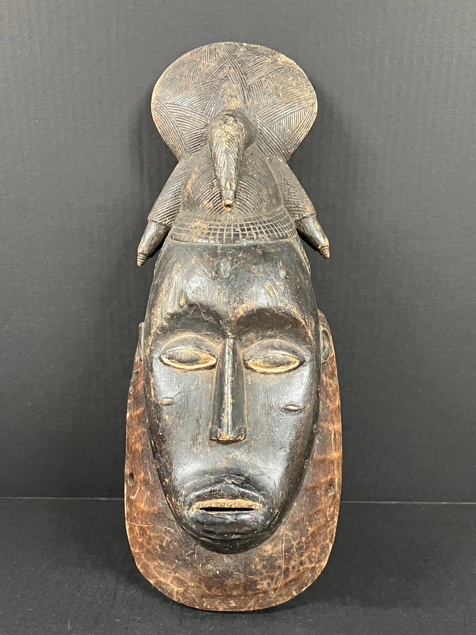 Baule Mask: African Tribal Art Baule Mask. The dimension is 18 inches high x 5.5 inches depth x 7 inches wide. Please be aware that some of the items are vintage, secondhand, old ages, antiques and may have a def