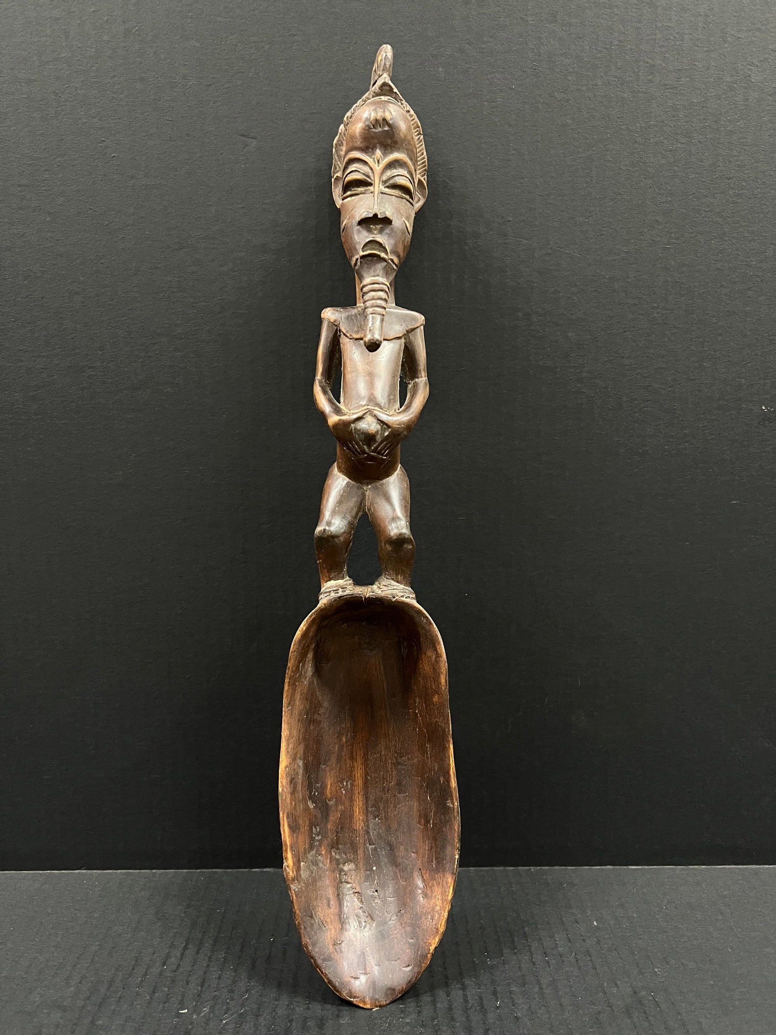 Baule Spoon: African Tribal Art Baule Spoon. The dimension is 19.5 inches high x 4 inches wide. Please be aware that some of the items are vintage, secondhand, old ages, antiques and may have a defects or sign of